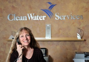 A Clean Water Services employee helps a community member file a permit at the Permits counter in Hillsboro